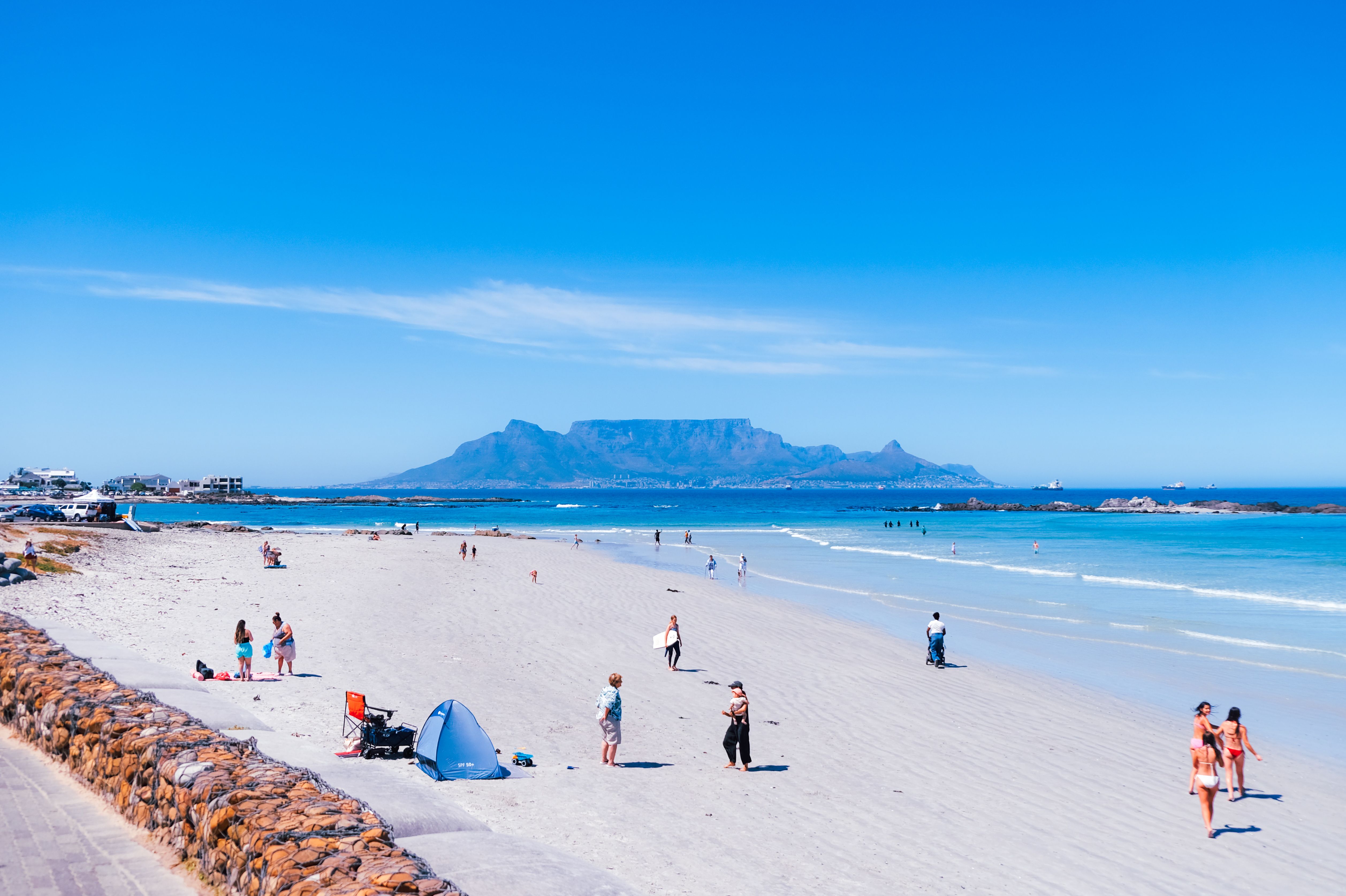 Sunny Bloubergstrand Beach in Cape Town with Table Mountain across the water.