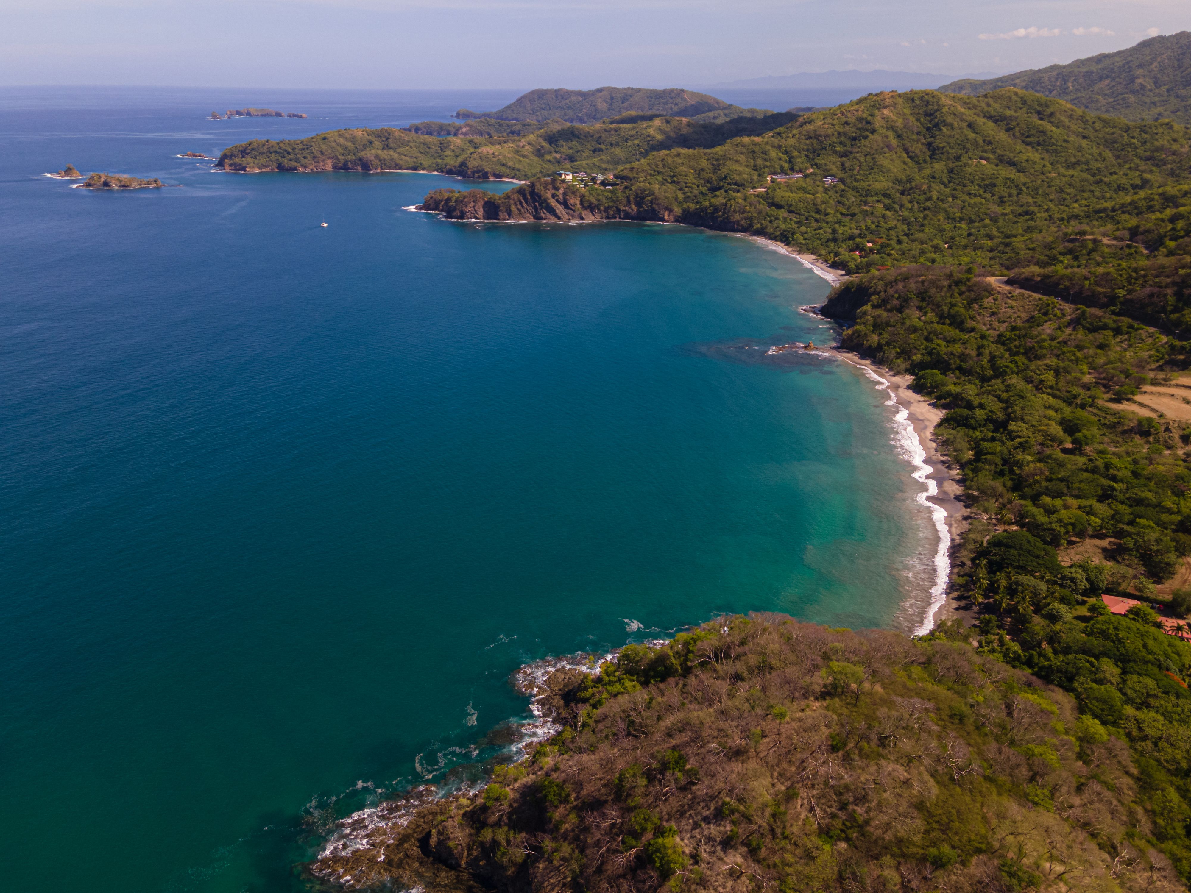 Aerial view of the lush Guanacaste coastline and blue Pacific waters in Costa Rica.