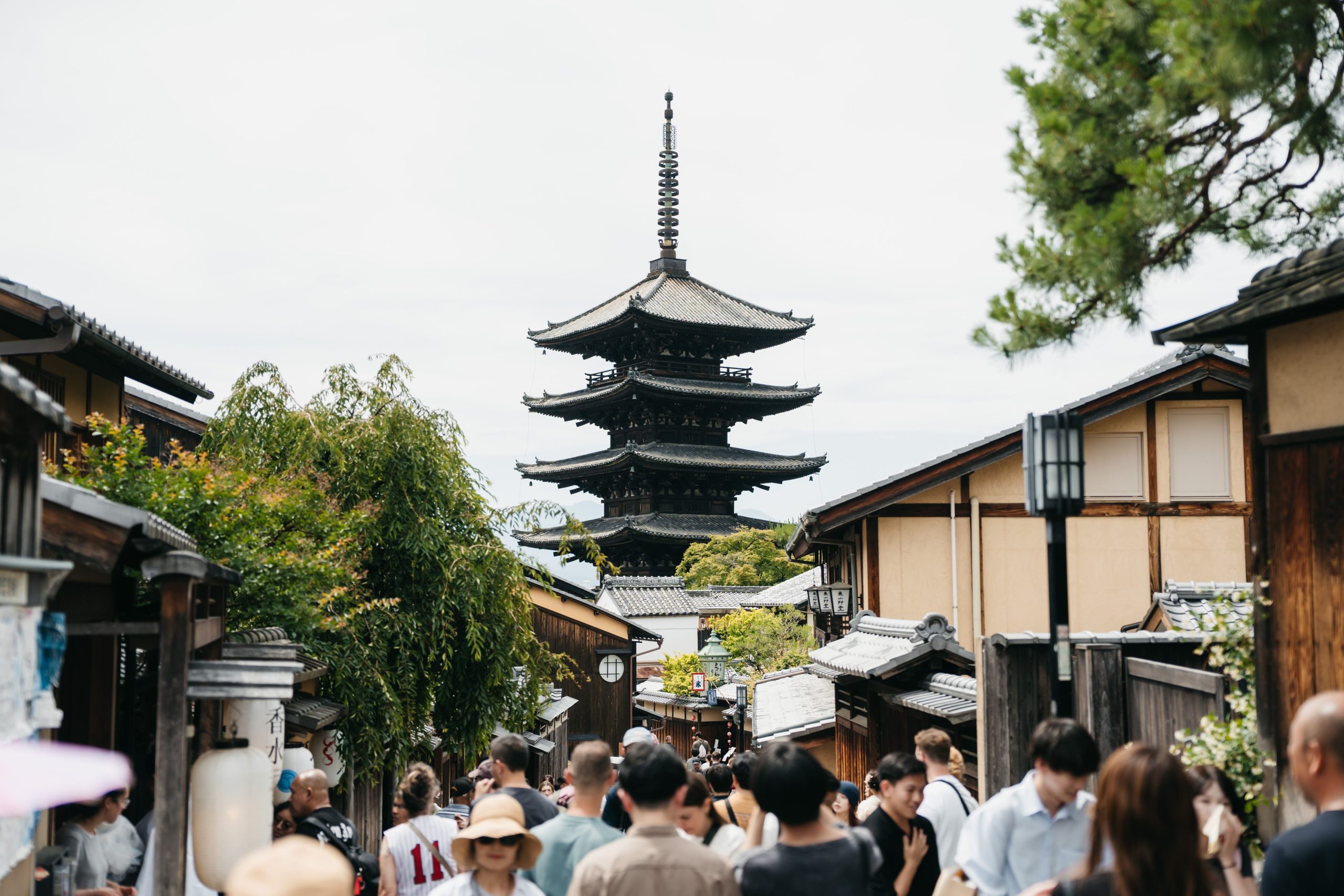 Bustling Kyoto street framed by traditional architecture and Yasaka Pagoda in Japan.